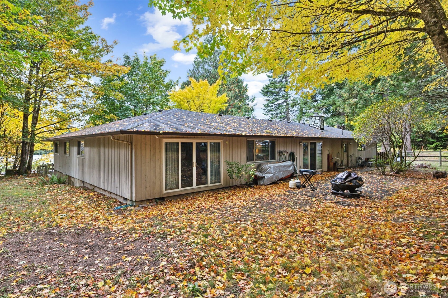 5700 Cooper Point Road Northwest Olympia, WA 98502 - Photo 6 of 31 a front view of house with yard outdoor seating and barbeque oven