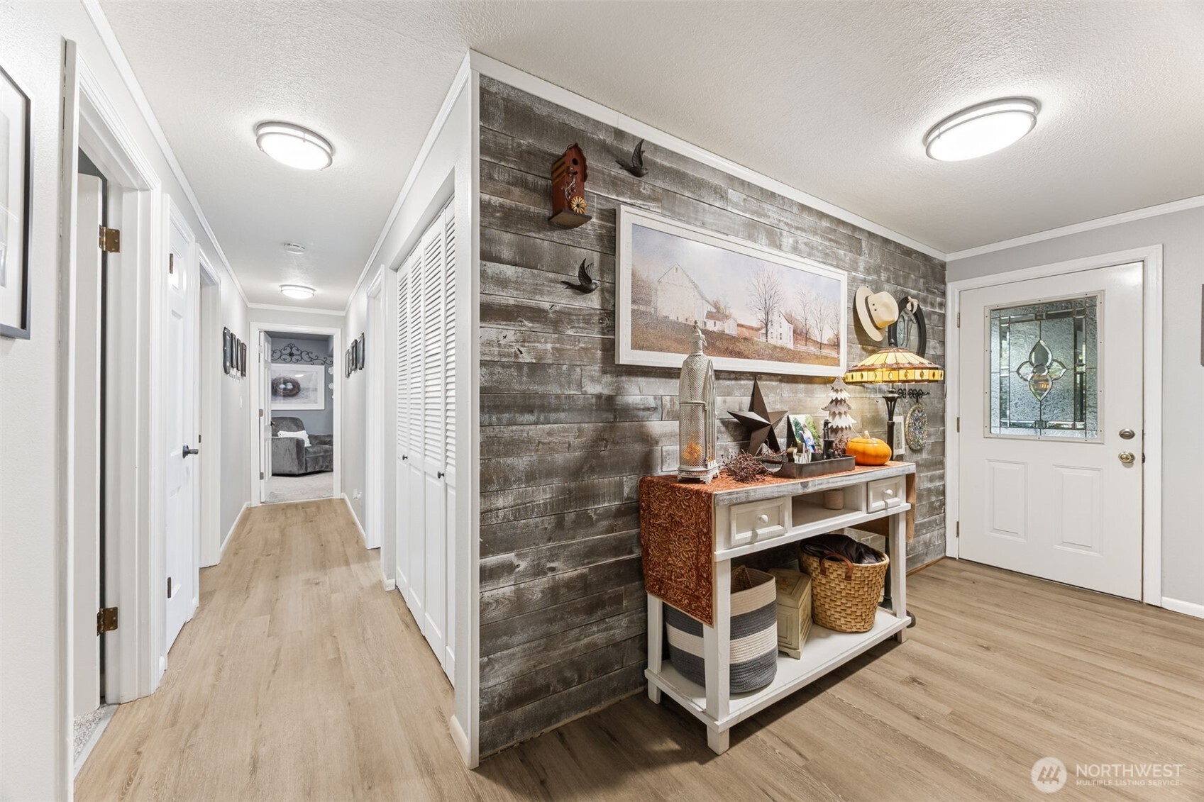 5700 Cooper Point Road Northwest Olympia, WA 98502 - Photo 8 of 31 a view of hallway with stairs and wooden floor