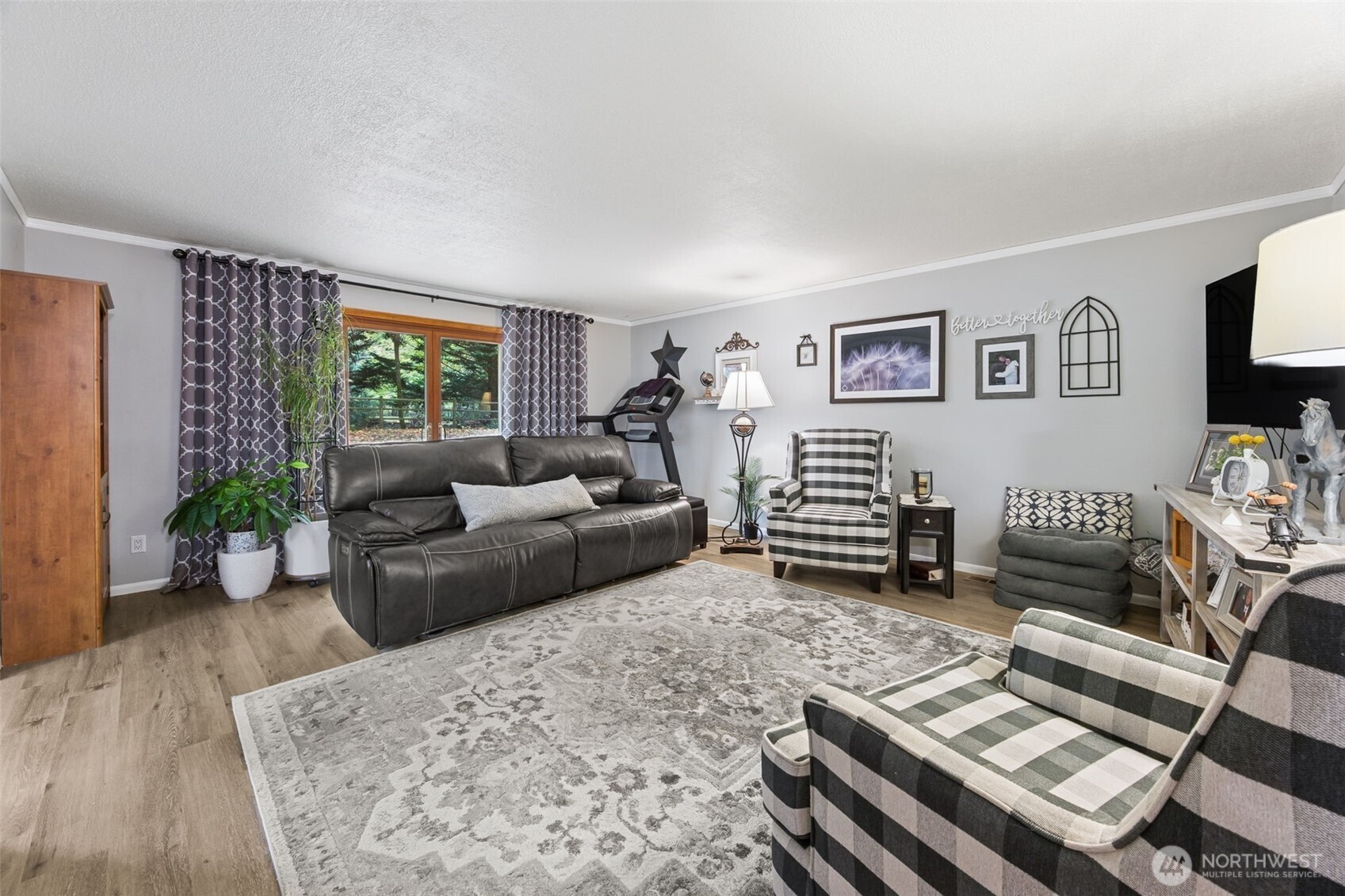 5700 Cooper Point Road Northwest Olympia, WA 98502 - Photo 9 of 31 a living room with furniture and wooden floor
