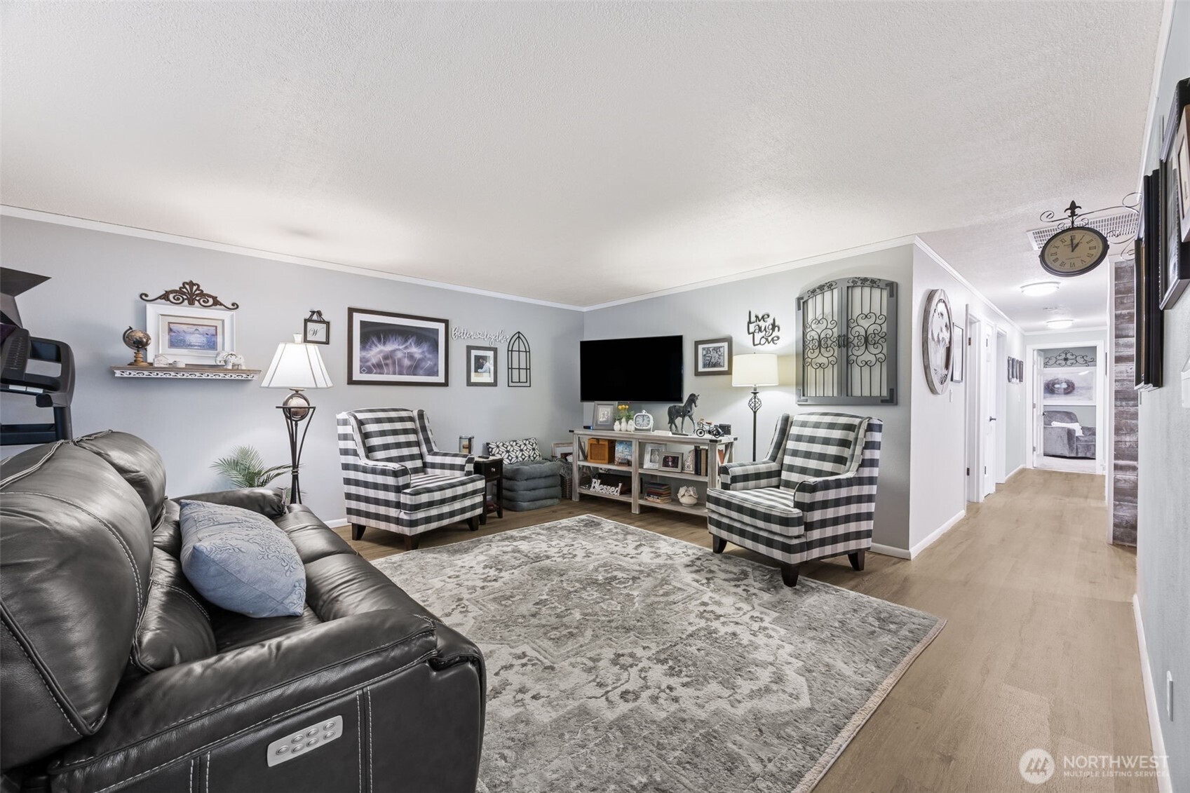 5700 Cooper Point Road Northwest Olympia, WA 98502 - Photo 10 of 31 a living room with furniture and a flat screen tv