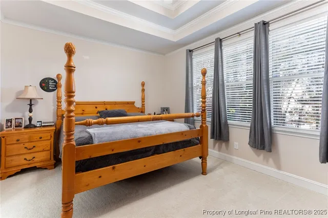 a bedroom with a bed and large windows