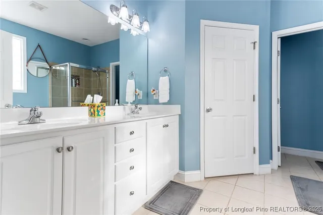 a bathroom with a sink vanity and a mirror