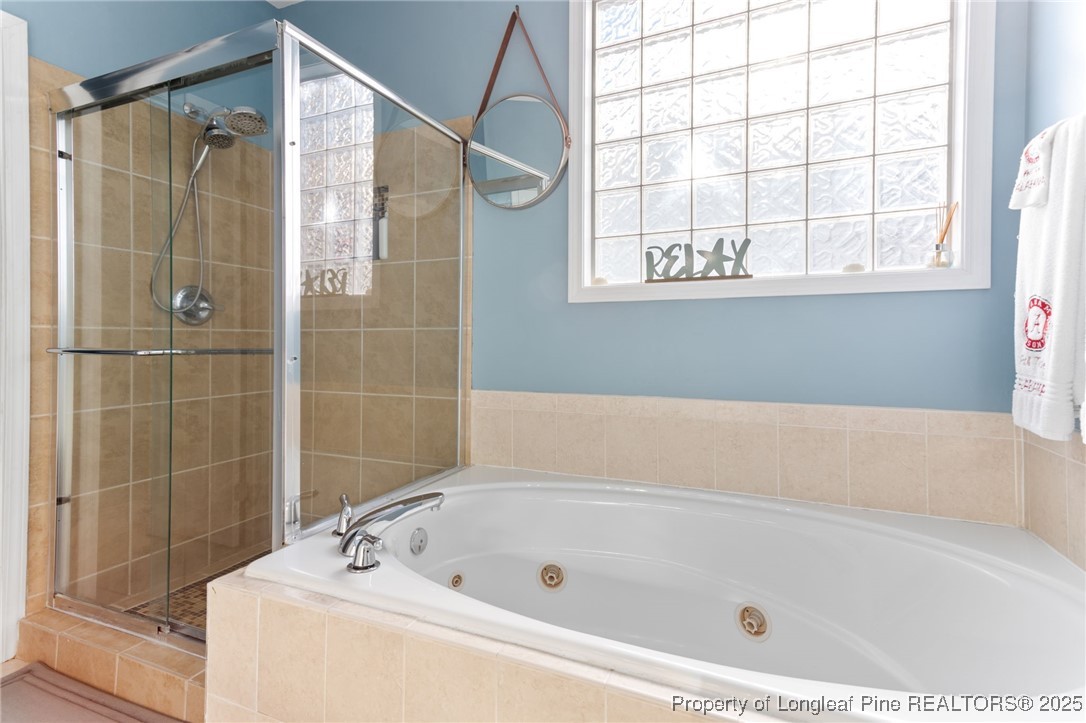 58 Cottswold Lane Spring Lake, NC 28390 - Photo 19 of 47 a bathroom with a tub a window and a shower