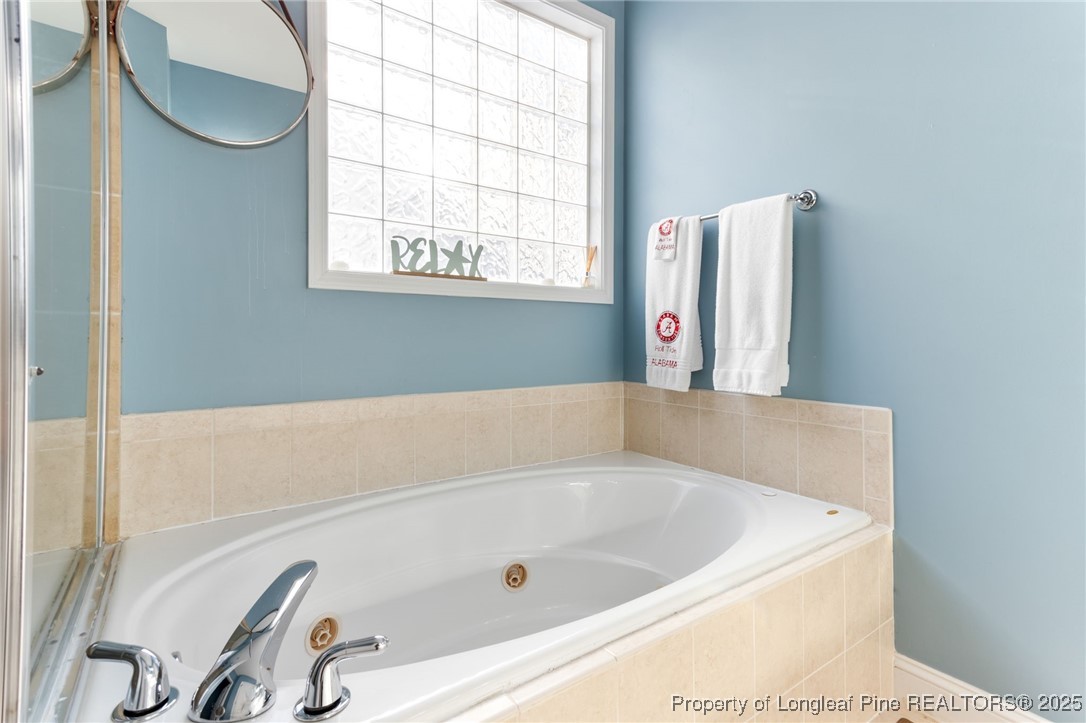 58 Cottswold Lane Spring Lake, NC 28390 - Photo 20 of 47 a bathroom with a bathtub and a window