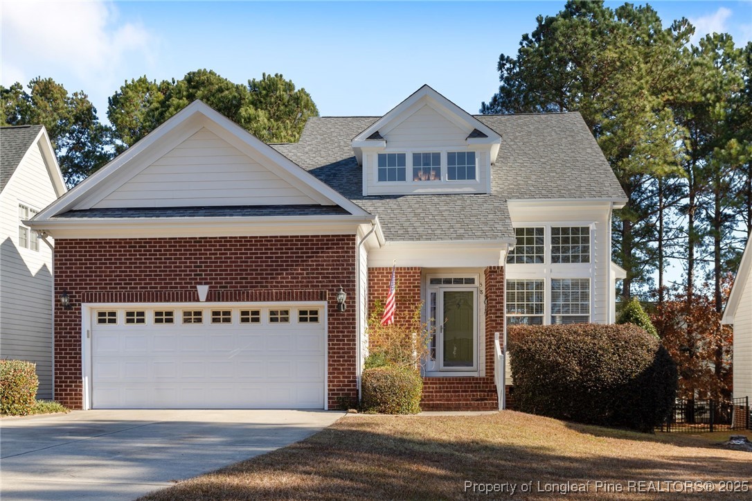 58 Cottswold Lane Spring Lake, NC 28390 - Photo 2 of 47 a front view of a house with a yard and garage