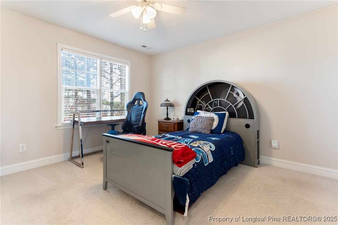 58 Cottswold Lane Spring Lake, NC 28390 - Photo 22 of 47 a bed room with a bed and a chandelier