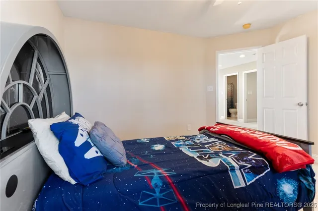 a bedroom with a bed and a mirror