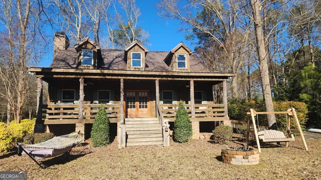 a view of a house with backyard porch and sitting area