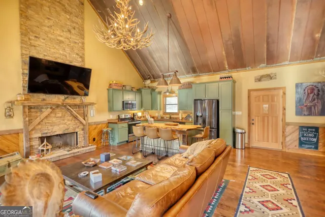 a living room with a table chairs and a flat screen tv