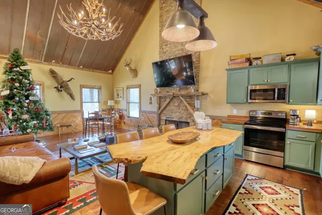 a view of a kitchen with granite countertop a sink and a stove