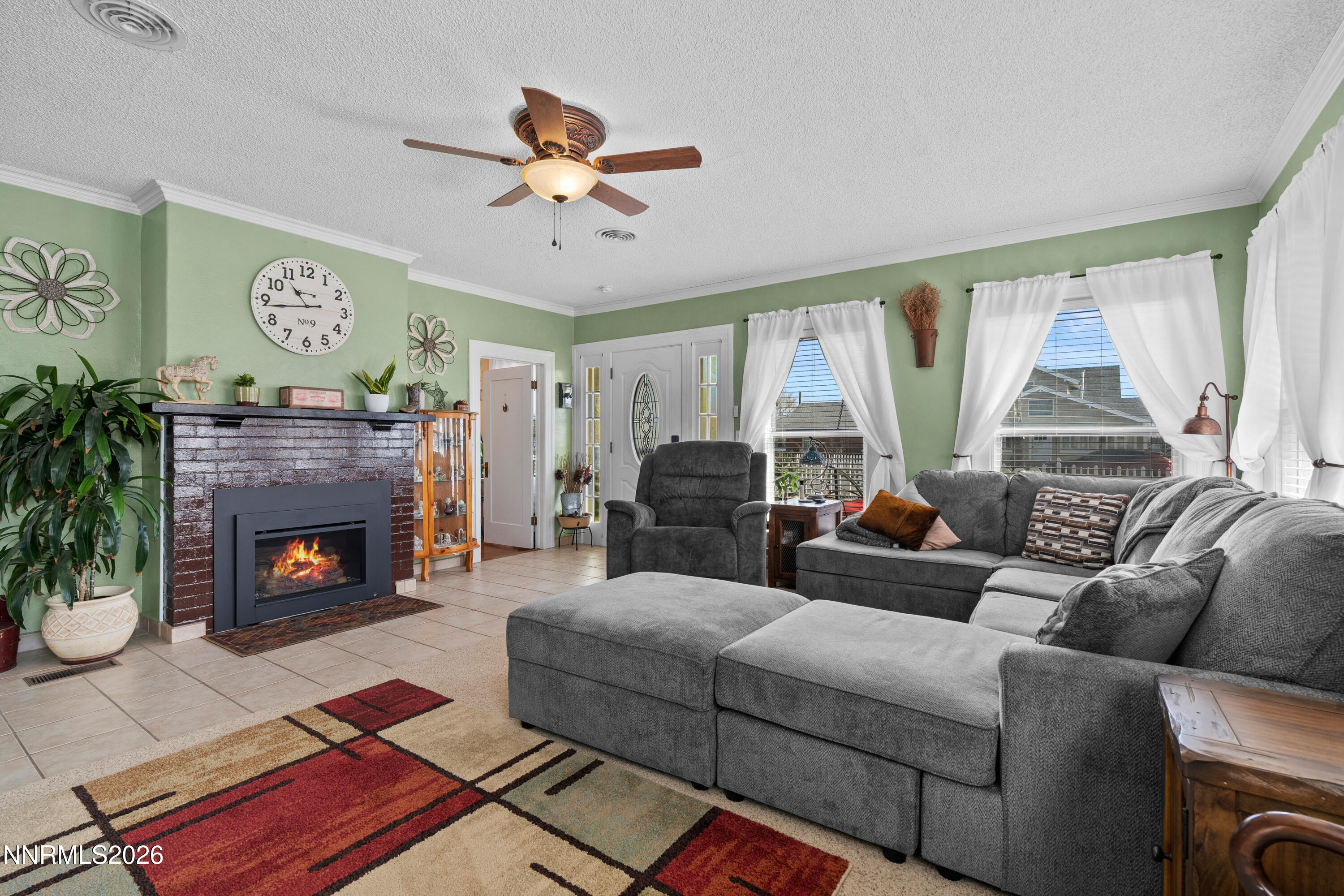 90 South Allen Street Fallon, NV 89406 - Photo 5 of 41 a living room with furniture a fireplace and a large window