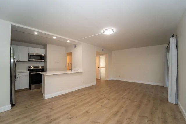 a view of a kitchen with a sink and a stove top oven