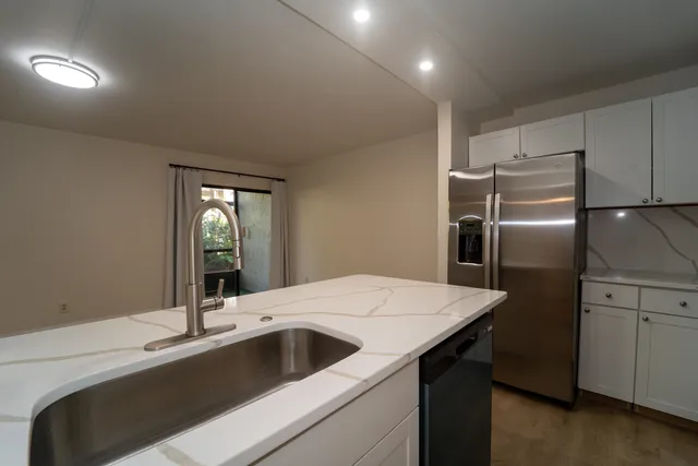 a kitchen with a sink and refrigerator