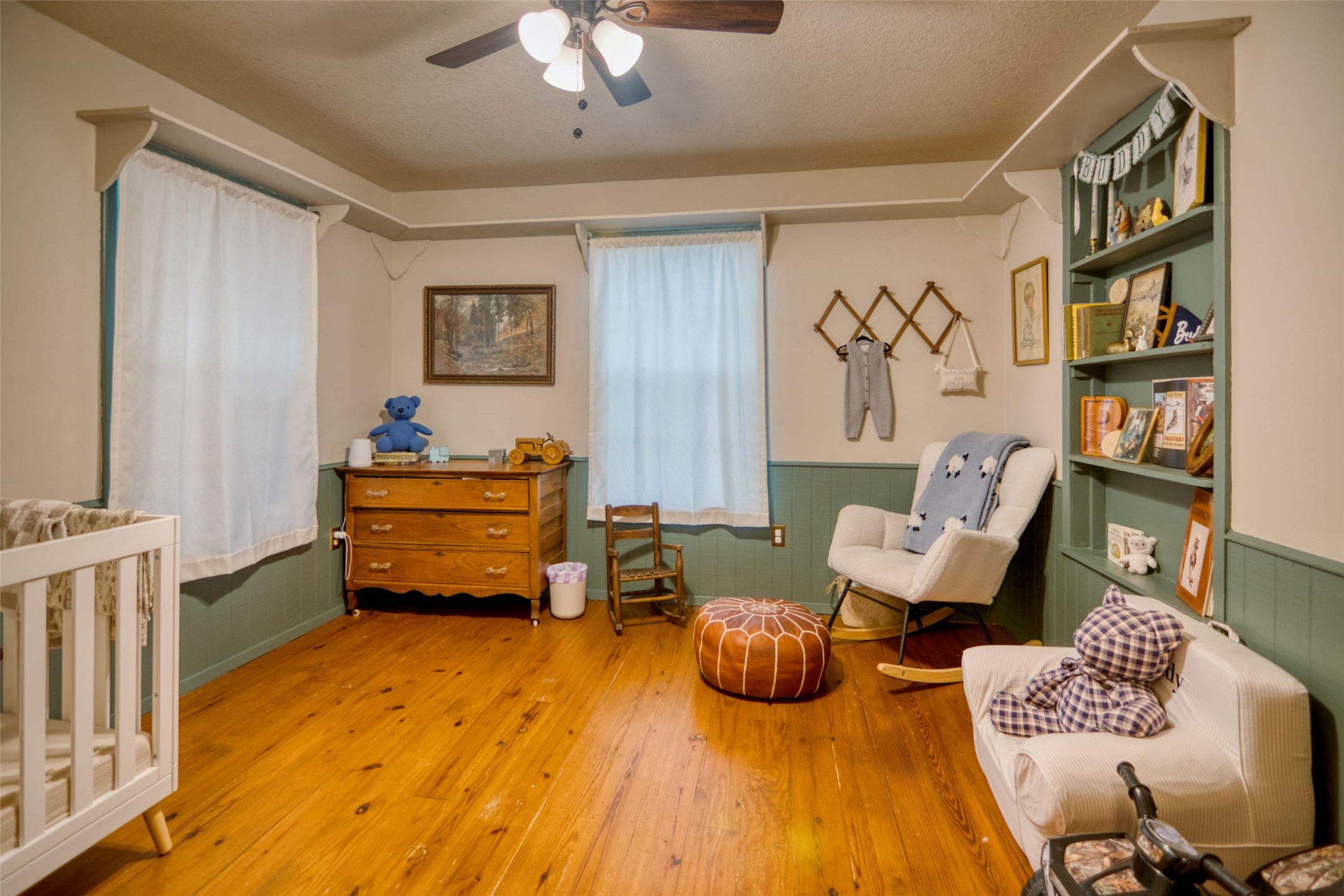 904 Bluebonnet Road Mason, TX 76856 - Photo 18 of 28 Room featuring wood-finish flooring, two windows, and a ceiling fan with light fixture