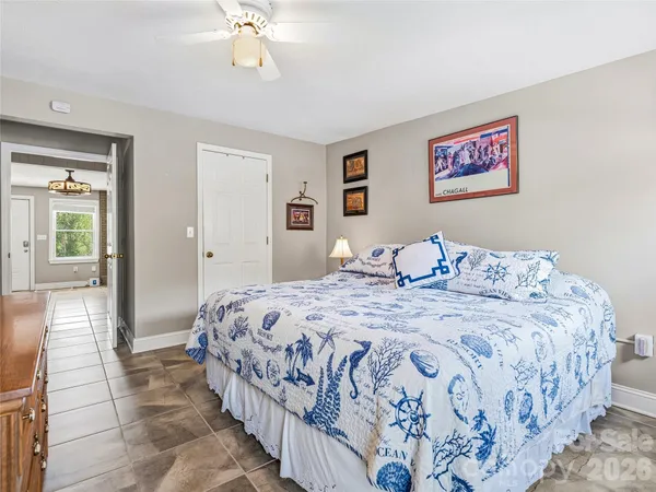 a bedroom with bed and wooden floor