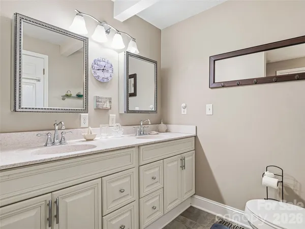 a bathroom with a double vanity sink and a mirror