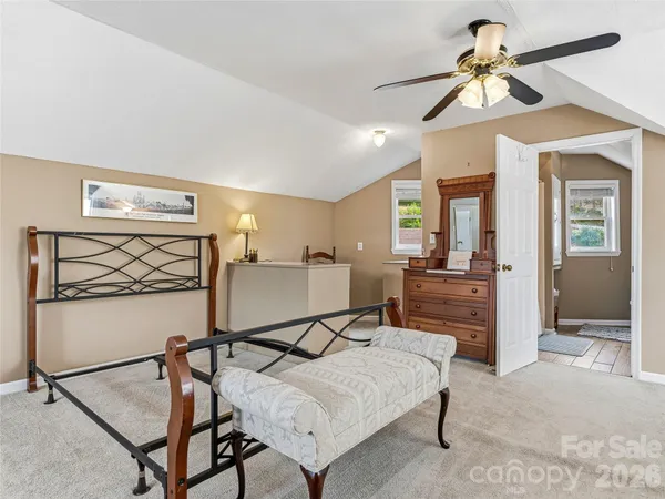 a bedroom with furniture and a chandelier