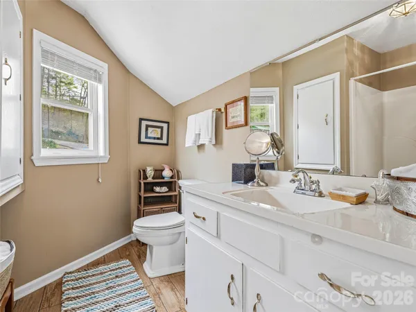 a bathroom with a sink toilet and a mirror