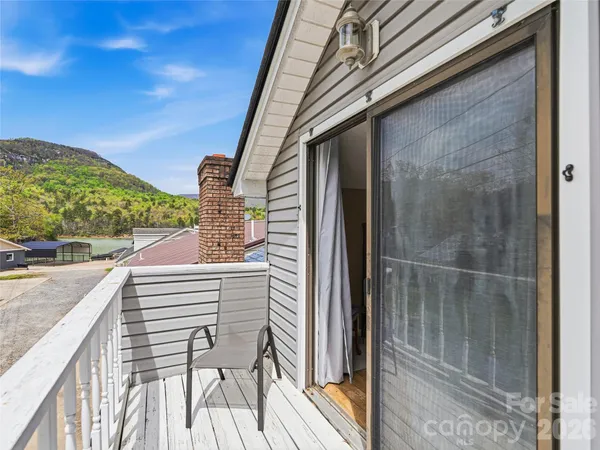 a view of a balcony with furniture and a potted plant