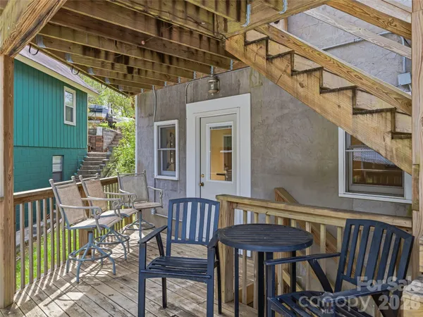a view of a balcony with furniture and wooden deck