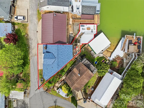 an aerial view of multiple houses with yard