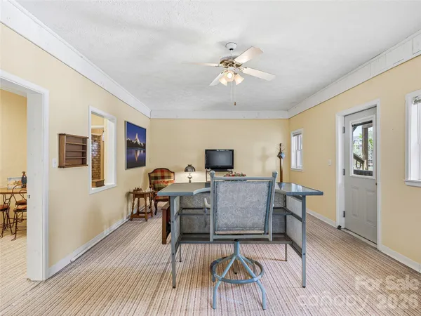 a living room with furniture a wooden floor and a chandelier