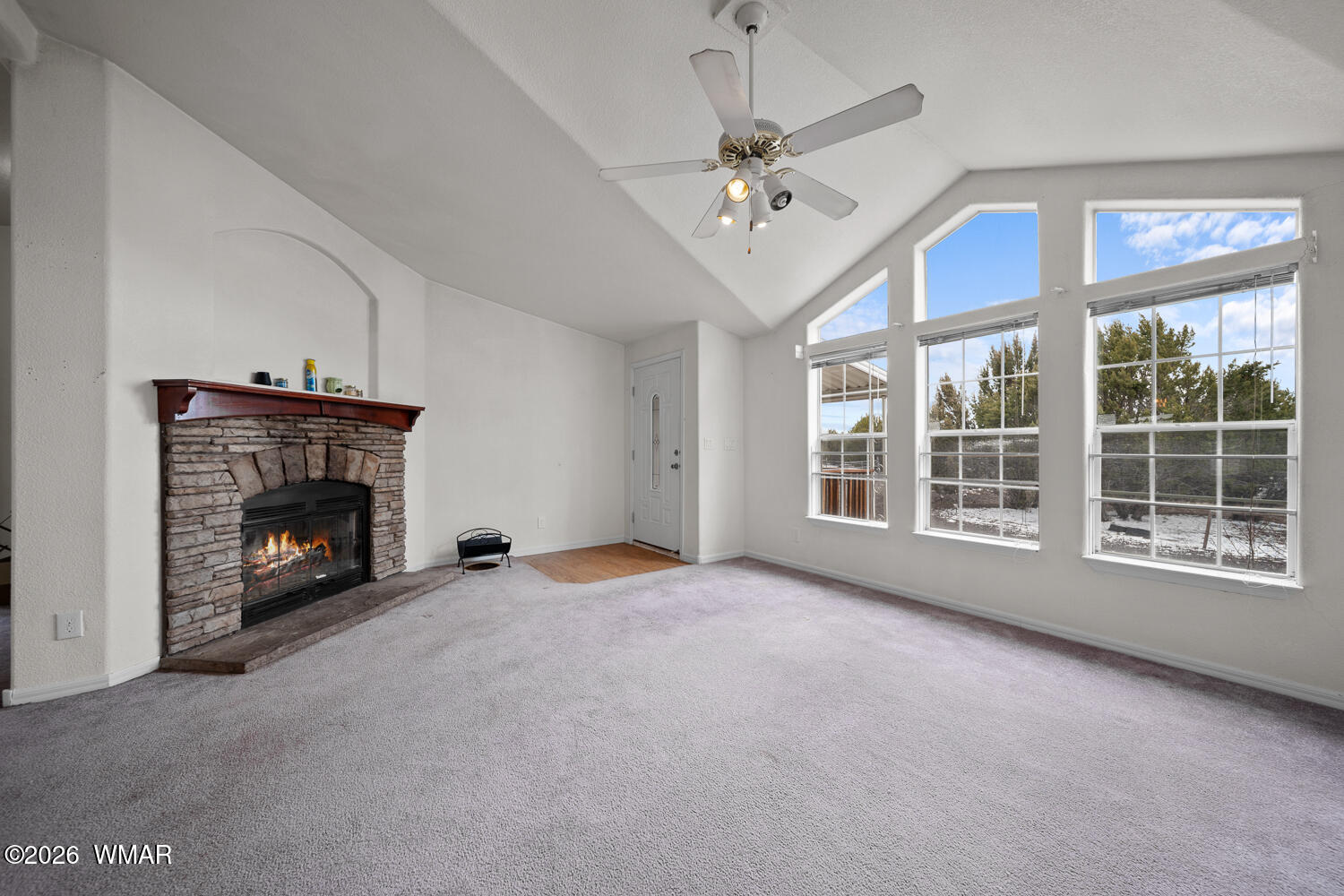 9 N3307 Show Low, AZ 85901 - Photo 22 of 50 a view of an empty room with furniture and a fireplace