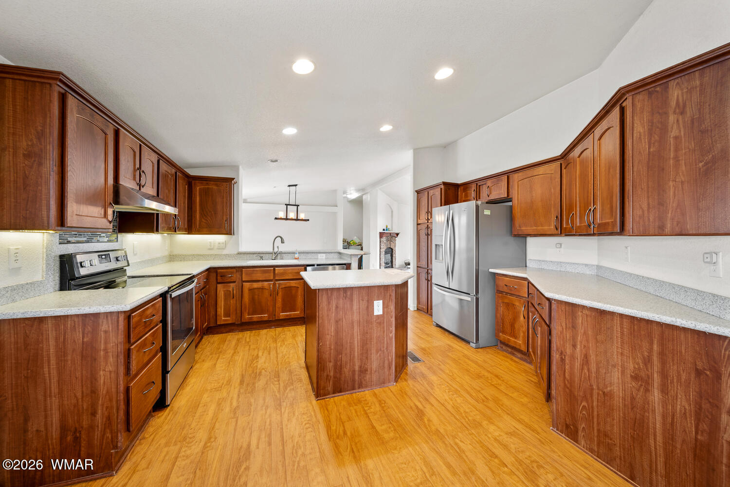 9 N3307 Show Low, AZ 85901 - Photo 29 of 50 a large kitchen with stainless steel appliances wooden cabinets a center island and a refrigerator