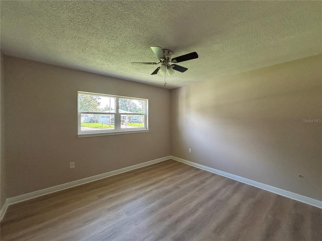 9950 52nd Terrace North St. Petersburg, FL 33708 - Photo 14 of 23 an empty room with wooden floor and windows