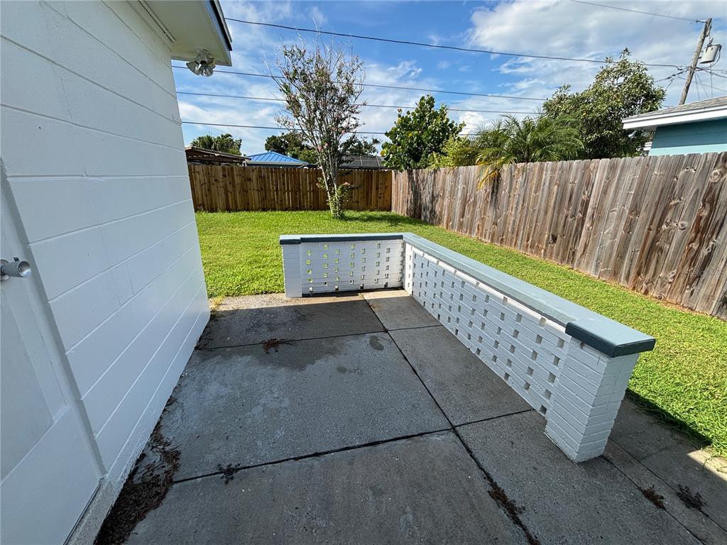 9950 52nd Terrace North St. Petersburg, FL 33708 - Photo 19 of 23 a view of a backyard with plants and wooden fence
