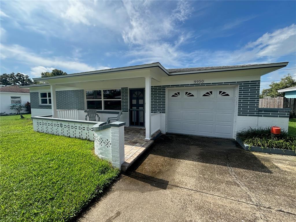 9950 52nd Terrace North St. Petersburg, FL 33708 - Photo 3 of 23 a front view of a house with garden