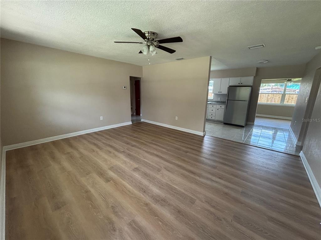 9950 52nd Terrace North St. Petersburg, FL 33708 - Photo 5 of 23 a view of a livingroom with wooden floor and a ceiling fan