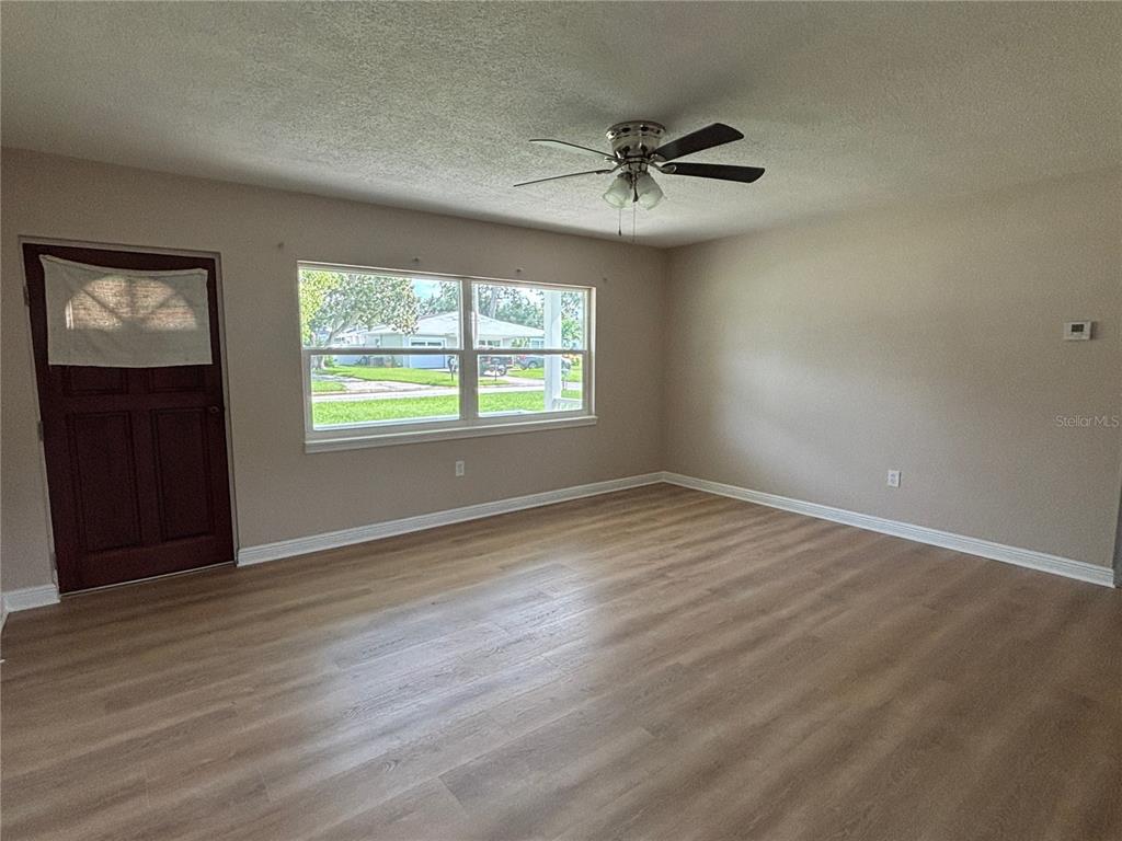 9950 52nd Terrace North St. Petersburg, FL 33708 - Photo 6 of 23 a view of an empty room with wooden floor and a window