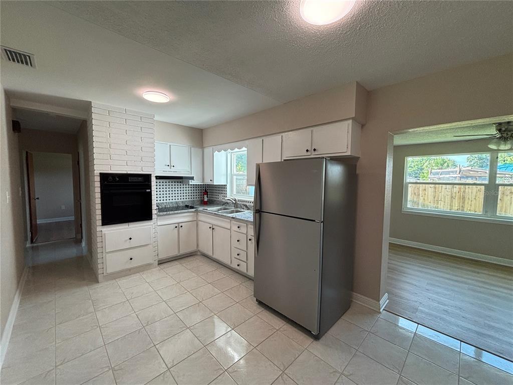 9950 52nd Terrace North St. Petersburg, FL 33708 - Photo 9 of 23 a kitchen with a refrigerator sink and cabinets