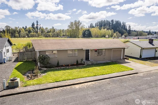a aerial view of a house with swimming pool and a yard