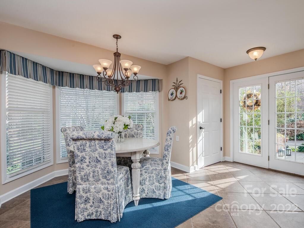 3039 High Ridge Road Charlotte, NC 28270 - Photo 16 of 26 a dining room with furniture a chandelier and window