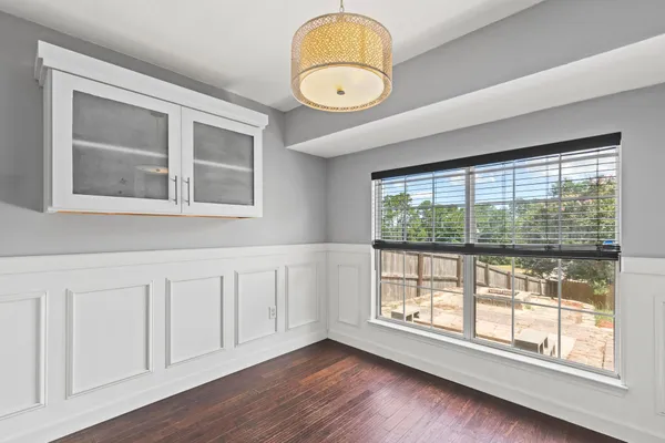 a view of an empty room with wooden floor