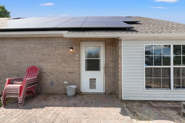 a front view of a house with outdoor seating