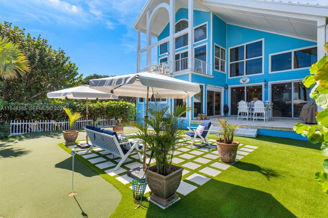 102 Xanadu Place Jupiter, FL 33477 - Photo 2 of 36 a view of a swimming pool with a patio