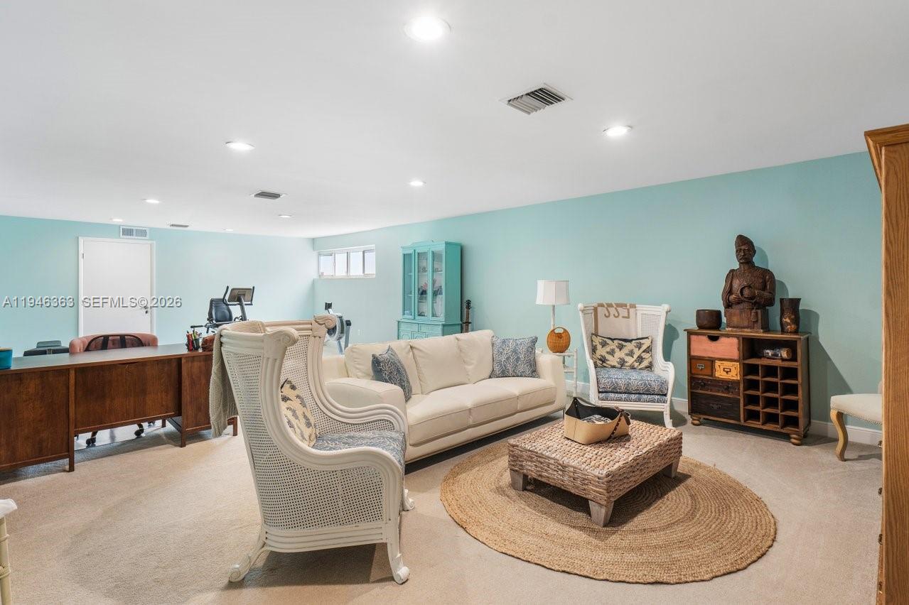 102 Xanadu Place Jupiter, FL 33477 - Photo 27 of 36 a living room with furniture and a wooden floor