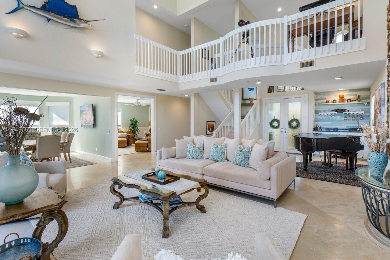 102 Xanadu Place Jupiter, FL 33477 - Photo 8 of 36 a living room with furniture and a dining table