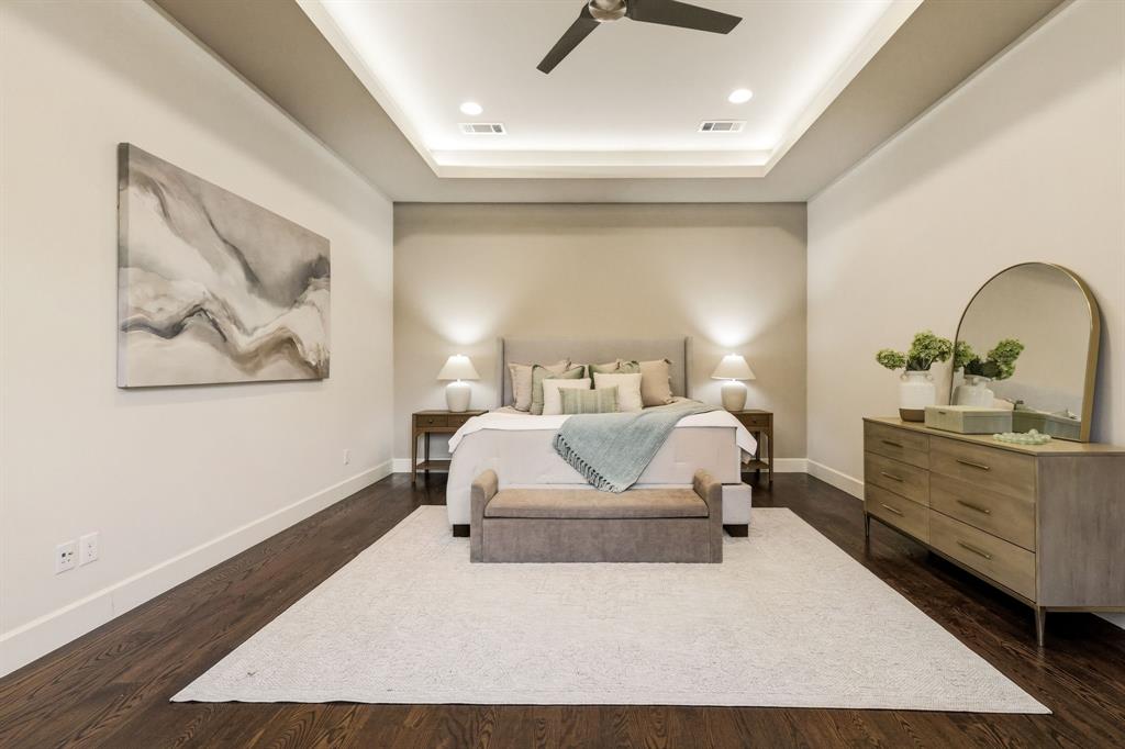 6523 Northwood Road Dallas, TX 75225 - Photo 18 of 36 a bedroom with a large bed and dresser