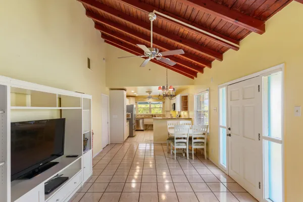 a view of a open kitchen with a table and chairs