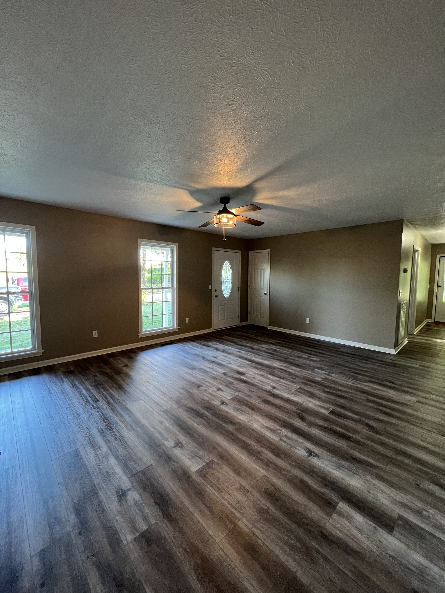 7220 McCormick Ridge Road Whitleyville, TN 38588 - Photo 2 of 9 an empty room with wooden floor and windows