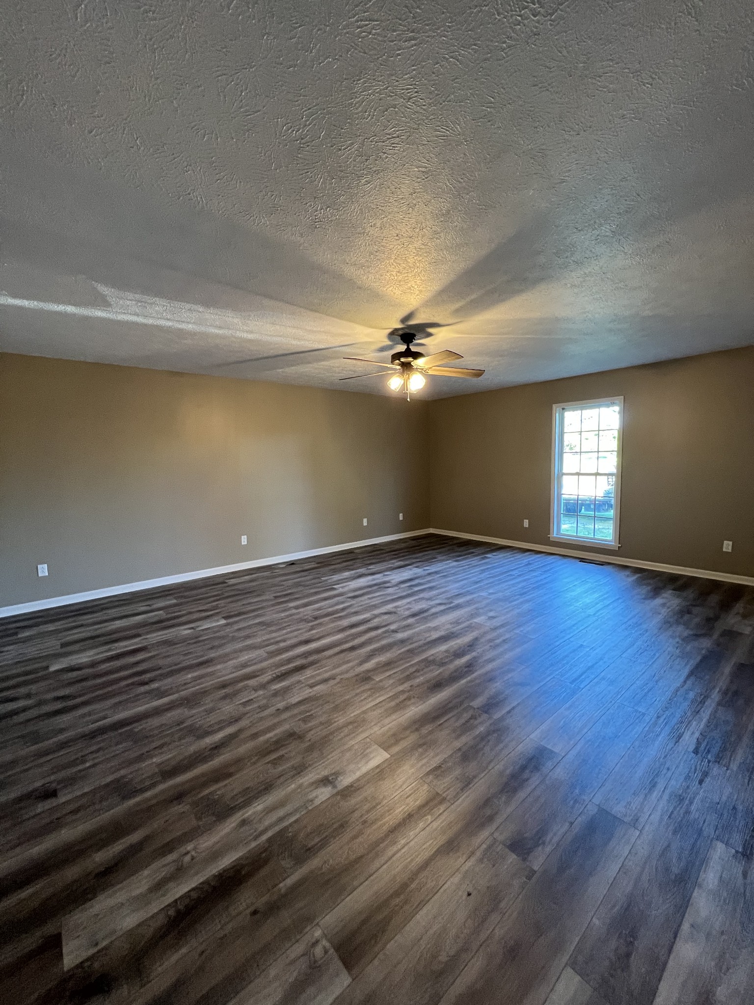 7220 McCormick Ridge Road Whitleyville, TN 38588 - Photo 4 of 9 a view of empty room with wooden floor and fan
