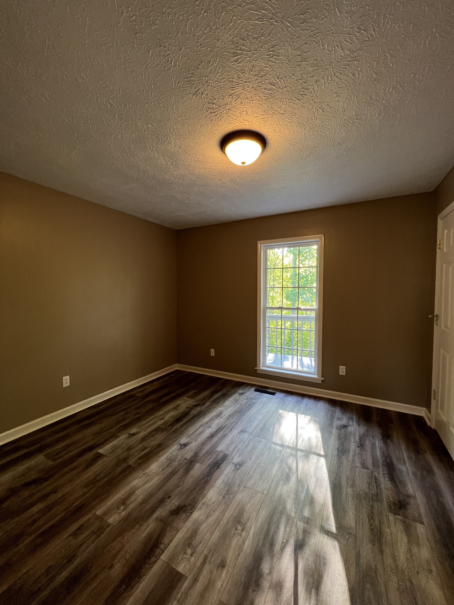 7220 McCormick Ridge Road Whitleyville, TN 38588 - Photo 8 of 9 a view of an empty room with wooden floor and a window