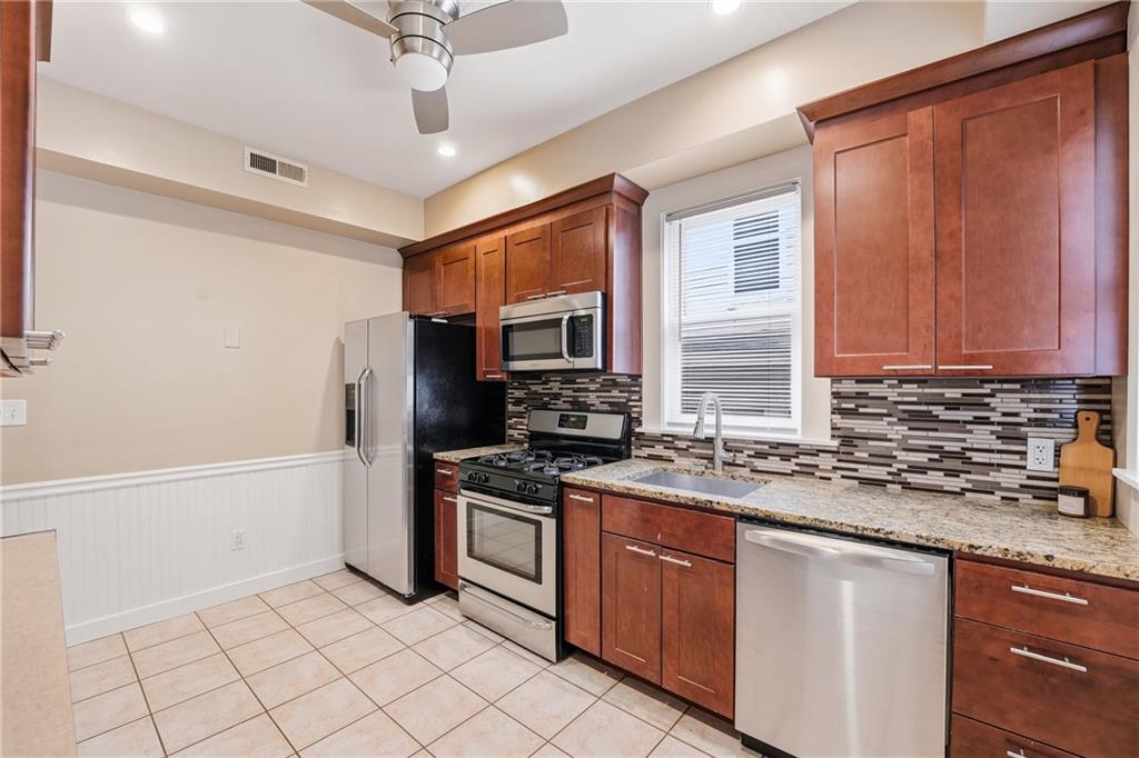 233 South Starr Avenue Pittsburgh, PA 15202 - Photo 12 of 43 a kitchen with stainless steel appliances granite countertop a stove a sink and a refrigerator