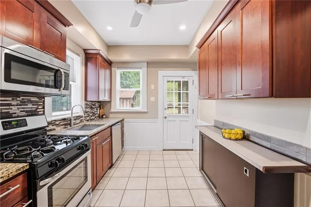 a kitchen with a stove a sink and a microwave