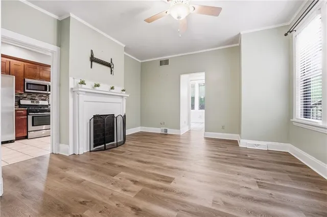 wooden floor fireplace and windows in an empty room