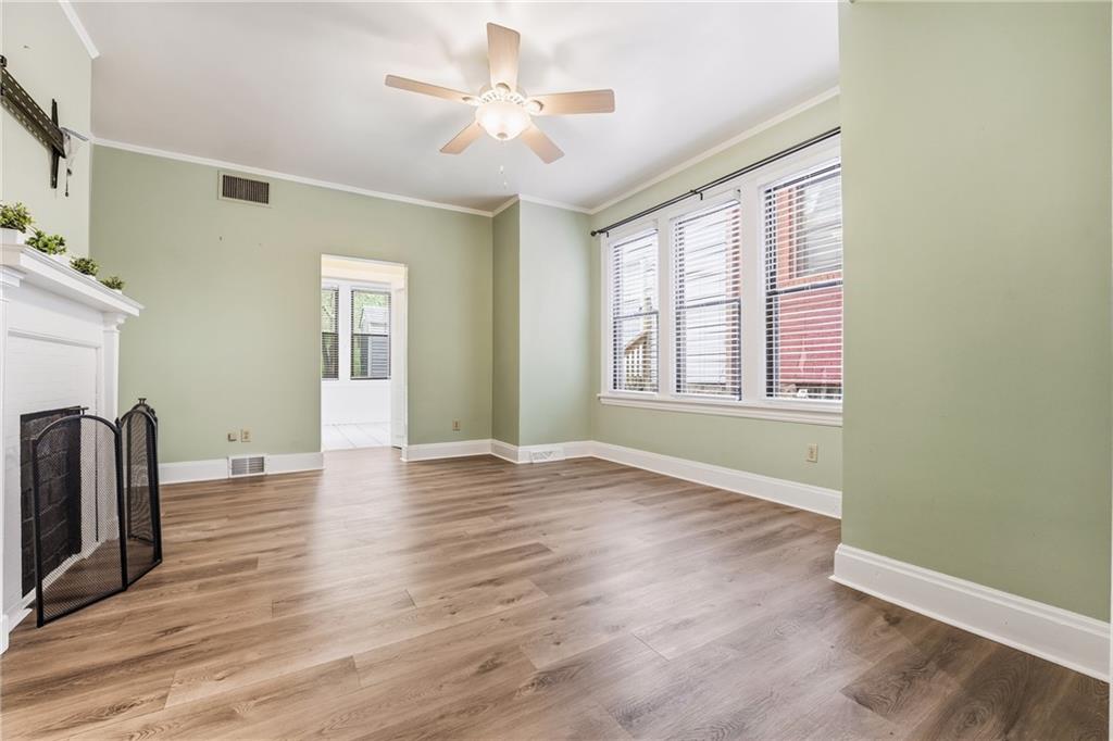 233 South Starr Avenue Pittsburgh, PA 15202 - Photo 16 of 43 a view of an empty room with window and wooden floor